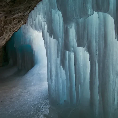 An image of large sheets of ice inside of an ice cave.