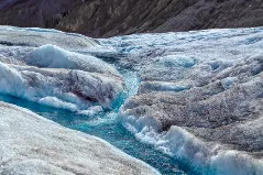 An image of river forming in a glacier.